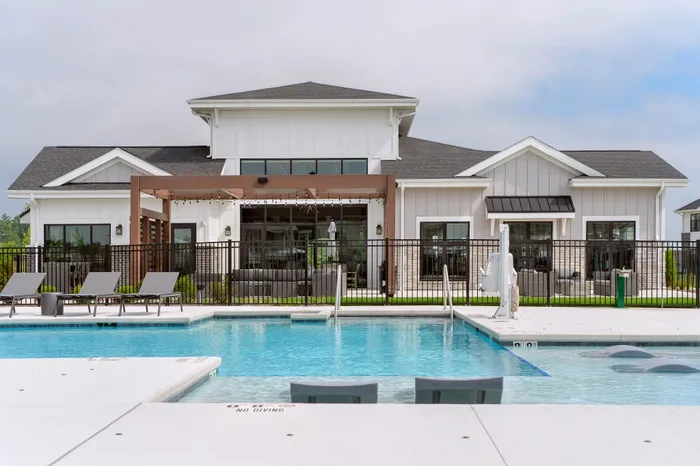 Outdoor pool at Seasons at Grafton Apartments in Grafton, Wisconsin offering space to relax, cool off, and enjoy warmer weather.