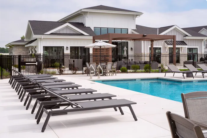 Outdoor pool at Seasons at Grafton Apartments in Grafton, Wisconsin offering space to relax, cool off, and enjoy warmer weather.