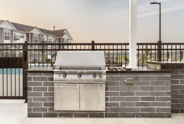 Community grill station and outdoor dining area at Apex at Verona in Verona, WI