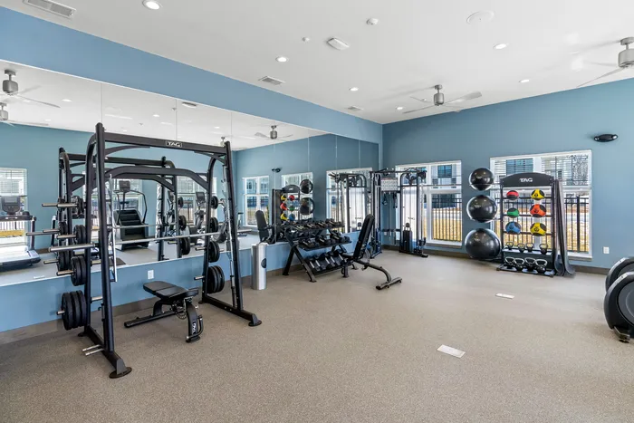 Fitness center with cardio machines and weights at Seasons at Spring Street