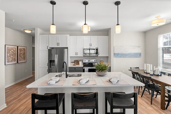 Apartment kitchen with stainless steel appliances and open layout at Seasons at Spring Street