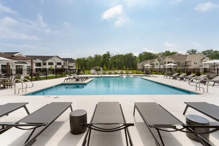 Swimming pool with lounge chairs and sun deck at Seasons at Spring Street