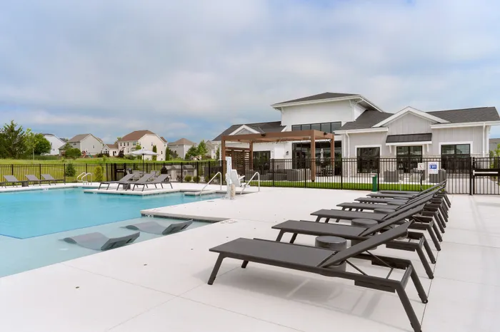 Swimming pool with lounge chairs and sun deck at Seasons at Spring Street