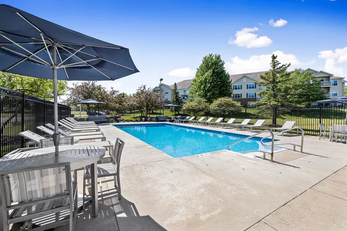 Sparkling outdoor pool deck at Riverwood Apartments in Kenosha, Wisconsin.