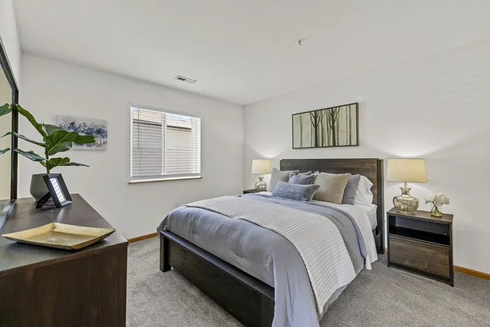 Bedroom at Saddlebrook Apartments in Pewaukee, Wisconsin with standard layout and finishes.