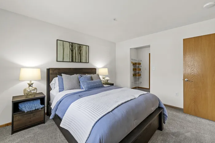 Bedroom at Saddlebrook Apartments in Pewaukee, Wisconsin with standard layout and finishes.