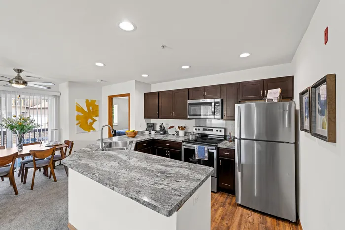 Apartment kitchen at Saddlebrook Apartments in Pewaukee, Wisconsin with functional layouts and finishes.