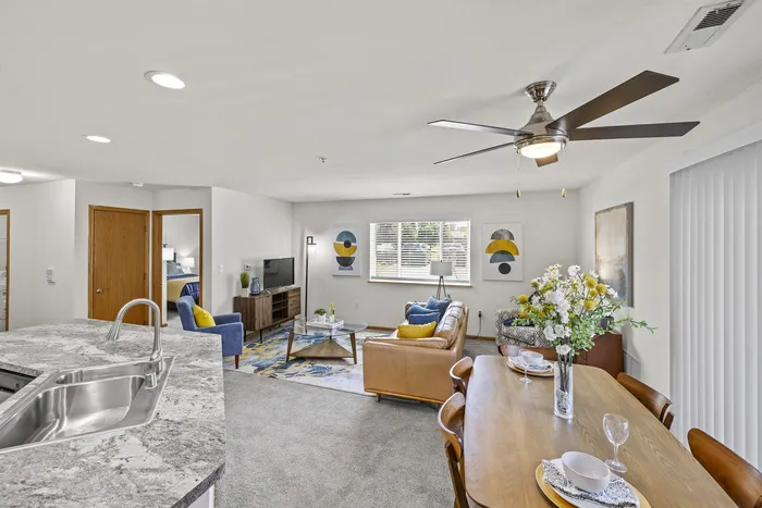 Living room at Saddlebrook Apartments in Pewaukee, Wisconsin with open layout and natural light.