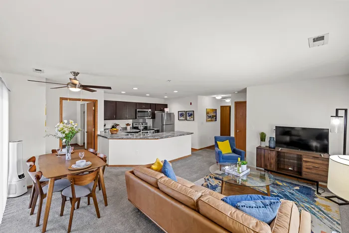 Living room at Saddlebrook Apartments in Pewaukee, Wisconsin with open layout and natural light.