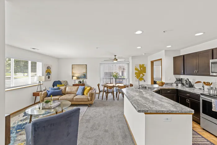 Living room at Saddlebrook Apartments in Pewaukee, Wisconsin with open layout and natural light.