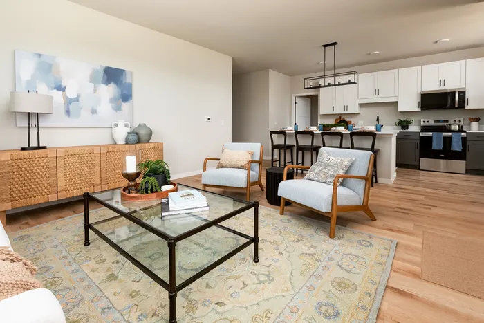 Modern kitchen with stainless steel appliances in a Terrapin Run stacked flat.