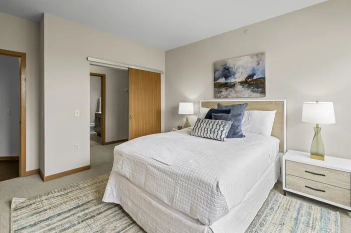 Carpeted modern bedroom at 50Twenty Apartments in Madison, Wisconsin.