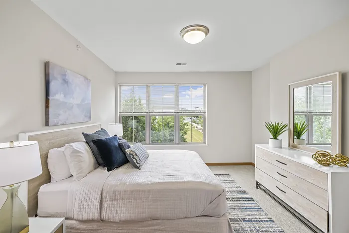 Carpeted modern bedroom at 50Twenty Apartments in Madison, Wisconsin.
