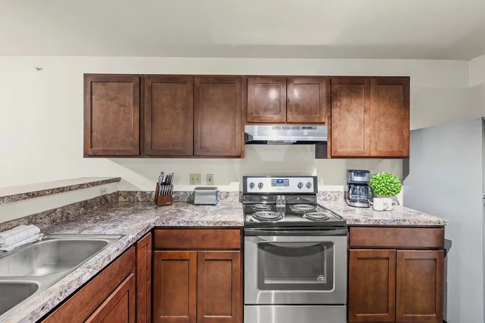 Kitchen with stainless steel appliances at Barrington Place Apartments in Madison, Wisconsin.