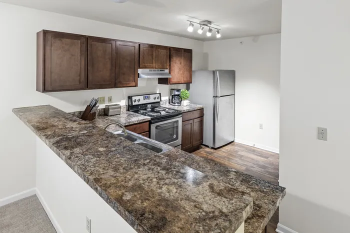 Kitchen with stainless steel appliances at Barrington Place Apartments in Madison, Wisconsin.