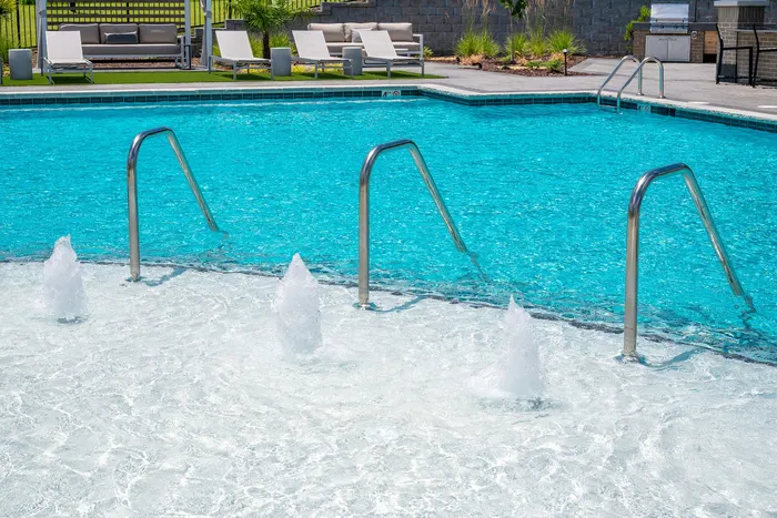 Resort-style swimming pool with lounge seating at Echelon at Charlotte