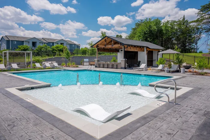 Resort-style swimming pool with lounge seating at Echelon at Charlotte