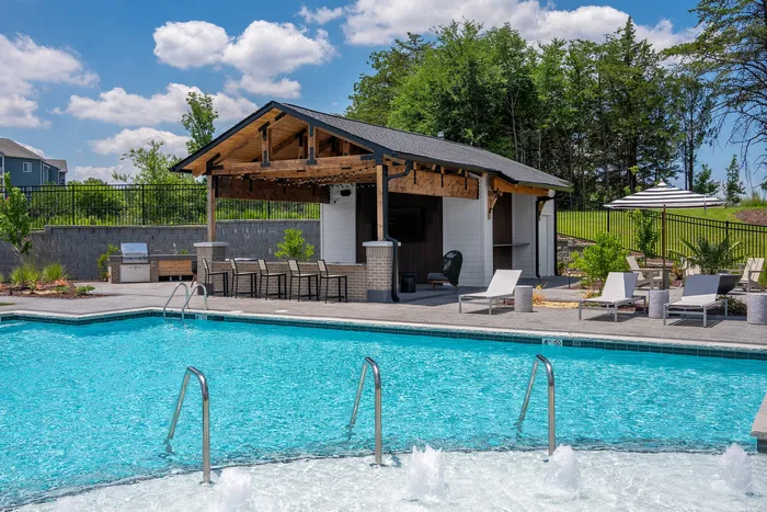 Resort-style swimming pool with lounge seating at Echelon at Charlotte