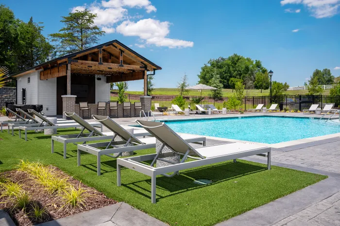 Resort-style swimming pool with lounge seating at Echelon at Charlotte