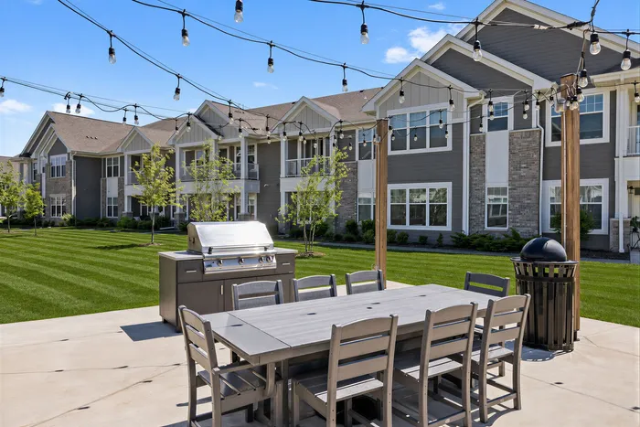 Luxury apartment grilling station and pergola with outdoor seating at Seasons at River View Apartments in Pleasant Prairie, Wisconsin.