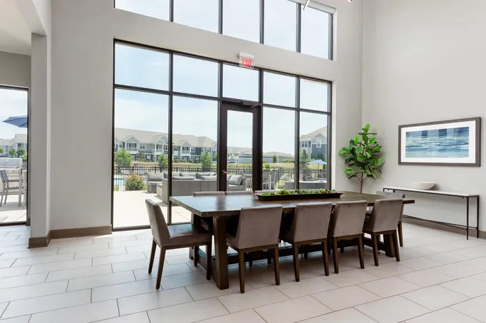 Clubhouse dining area with large community table at Seasons at Orchard Hills apartments in Oak Creek, Wisconsin.