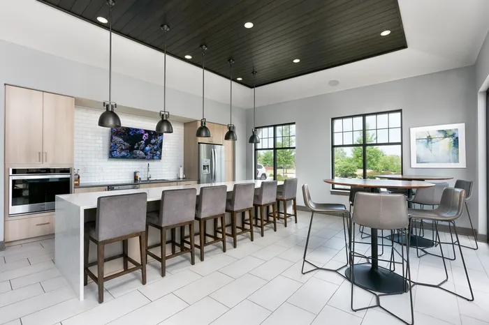 Resident clubhouse kitchen with bar seating at Seasons at Orchard Hills in Oak Creek, Wisconsin.