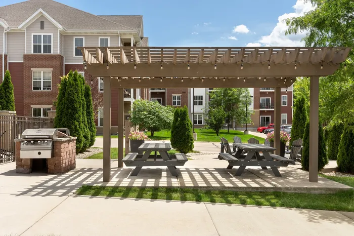 Outdoor picnic area at Elan Apartments in Fitchburg, Wisconsin offering shared seating and green space for residents.