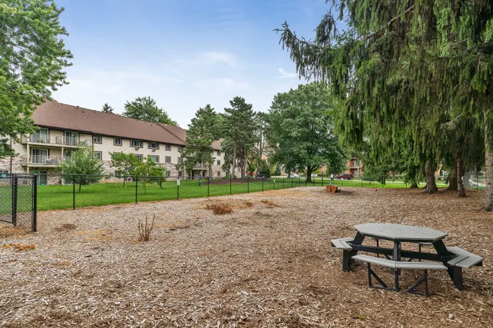 Fenced dog park with open space for resident pets at Valley View Apartments.