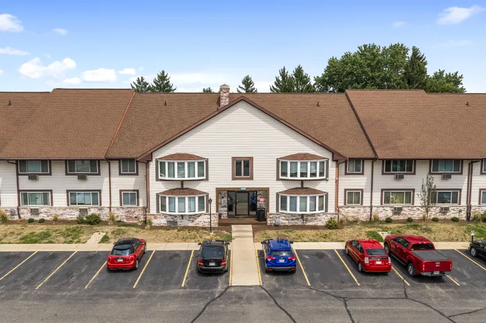 Exterior of a Valley View Apartments building with surface parking spaces.