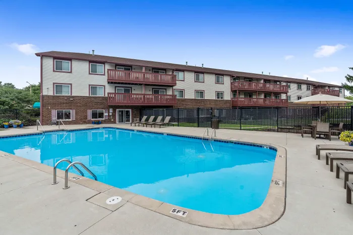 Outdoor pool and surrounding pool deck at Ridge View Apartments.