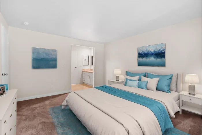Inviting bedroom with plush bedding, elegant decor, and a soothing color palette.