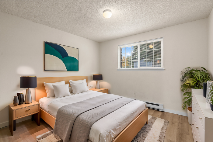 Inviting bedroom with a comfortable double bed, stylish artwork, and soft lighting.