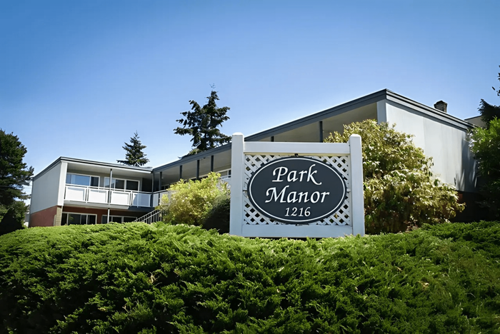 Elegant exterior view of Park Manor with lush greenery and a welcoming entrance.