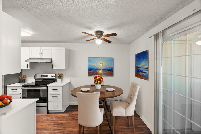 Bright kitchen and dining area with modern appliances and elegant decor.