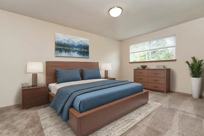 Elegant bedroom with modern wooden furniture, soothing blue bedding, and large window with scenic view.