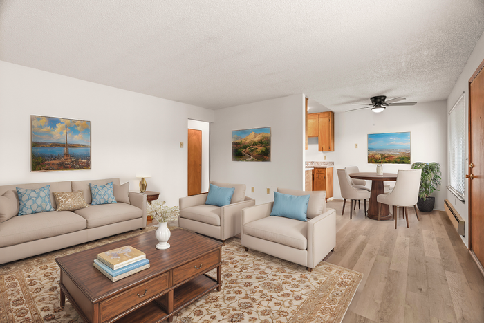 Spacious living room with contemporary furniture and adjoining dining area featuring wooden accents.