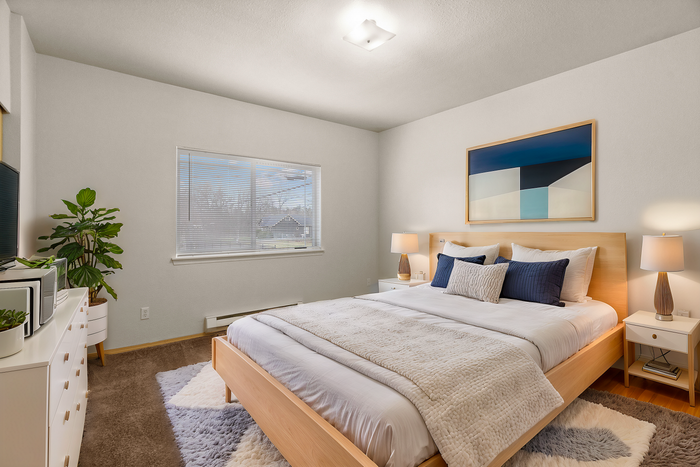 Inviting bedroom with modern decor, featuring a comfortable bed, stylish artwork, and soft lighting, perfect for relaxation.