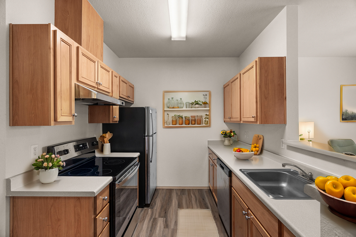 Modern kitchen with sleek appliances, wooden cabinets, and vibrant decor accents, offering a warm and inviting atmosphere.
