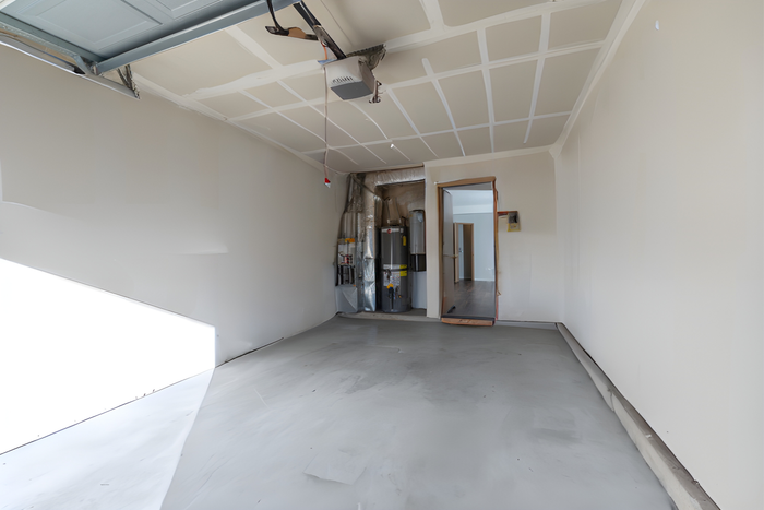 Spacious and bright garage with a modern automatic door, ready for storage or vehicle parking. Features direct access to home, enhancing convenience and functionality.