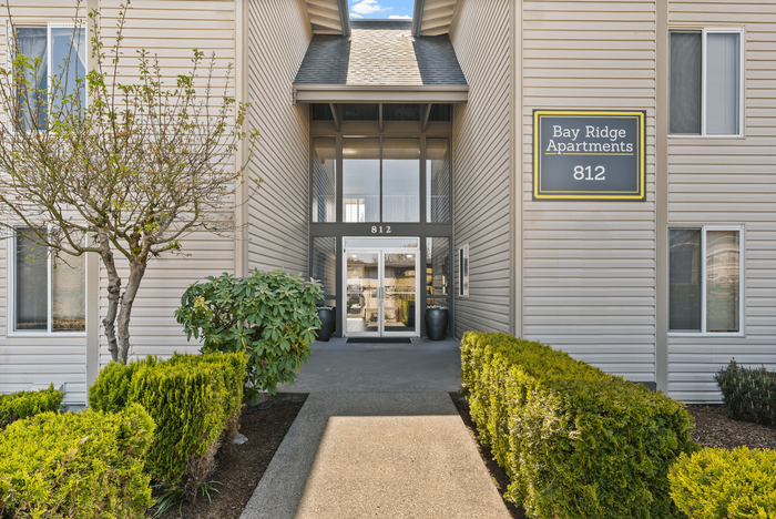 Elegant exterior of Bay Ridge Apartments featuring manicured landscaping and a welcoming entrance.
