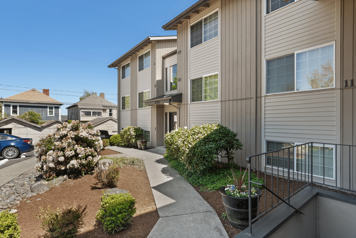 Modern apartment complex with well-maintained landscaping and inviting entrances.