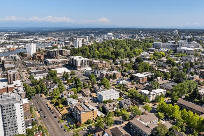 Vibrant urban neighborhood with lush greenery and modern high-rises, offering scenic city views.