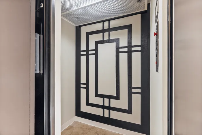 Chic modern hallway with geometric wall art and tiled flooring, perfect for stylish apartment entryway.