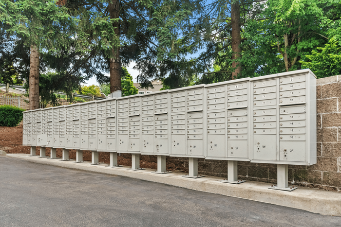 Convenient and spacious outdoor mailboxes set against lush greenery, providing secure and accessible mailing solutions.