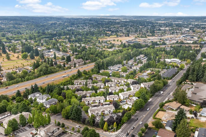 Stunning aerial view of a lush, vibrant suburban community featuring picturesque homes nestled among green trees and expansive landscapes.