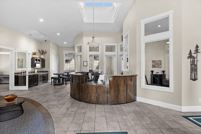 Inviting lobby area with elegant front desk, modern decor, and a well-lit open space perfect for welcoming guests.