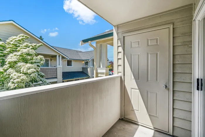 Charming apartment balcony with vibrant greenery and cozy architectural details, ideal for relaxation and enjoying serene views.