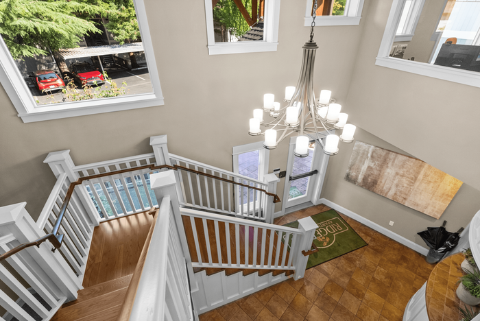 Beautifully designed staircase with ornate chandelier and elegant decor.