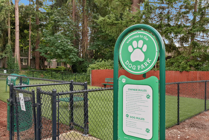 Inviting and well-maintained dog park with lush greenery and modern fencing for a safe and enjoyable pet experience.