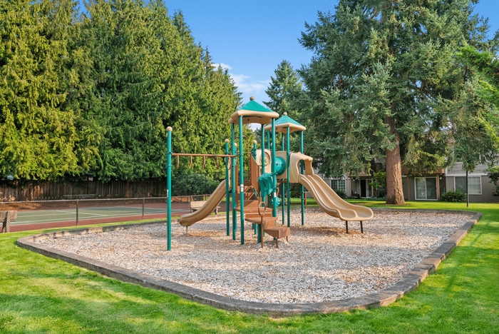 Gorgeous playground with modern slides set amidst lush greenery, perfect for family fun and outdoor activities.